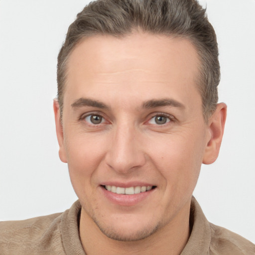 Joyful white adult male with short  brown hair and brown eyes