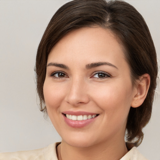 Joyful white young-adult female with medium  brown hair and brown eyes