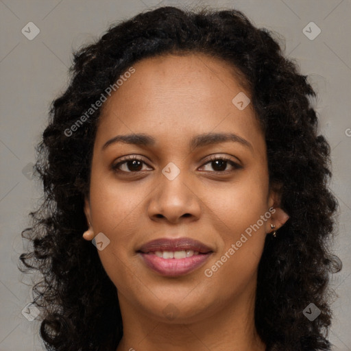 Joyful black young-adult female with long  brown hair and brown eyes