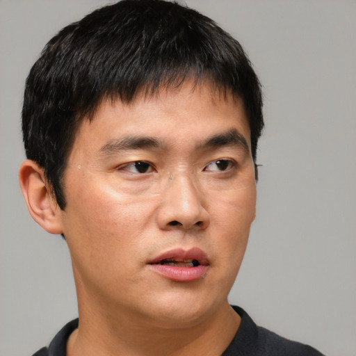 Neutral asian young-adult male with short  brown hair and brown eyes