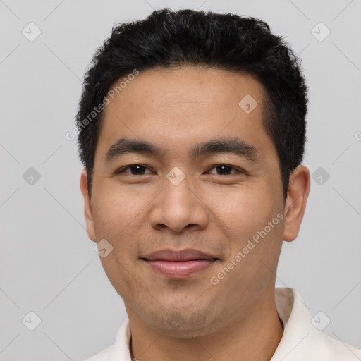 Joyful latino young-adult male with short  black hair and brown eyes