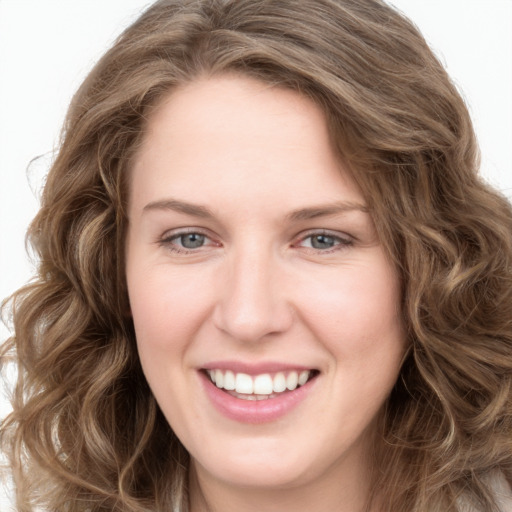 Joyful white young-adult female with long  brown hair and green eyes