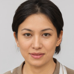 Joyful asian young-adult female with medium  brown hair and brown eyes