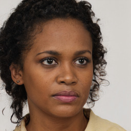 Neutral black young-adult female with medium  brown hair and brown eyes