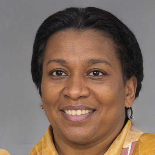 Joyful latino adult female with medium  brown hair and brown eyes