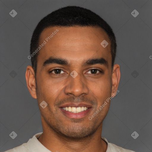 Joyful black young-adult male with short  black hair and brown eyes