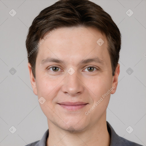 Joyful white young-adult male with short  brown hair and grey eyes