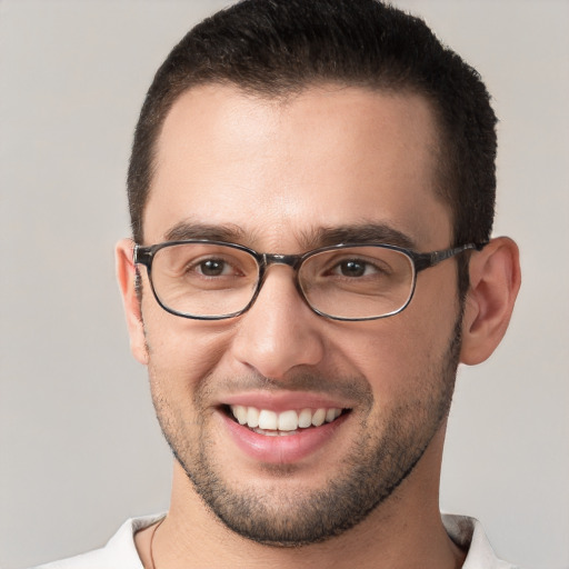 Joyful white young-adult male with short  brown hair and brown eyes