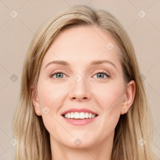 Joyful white young-adult female with long  brown hair and blue eyes