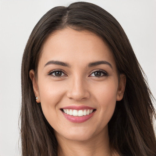 Joyful white young-adult female with long  brown hair and brown eyes