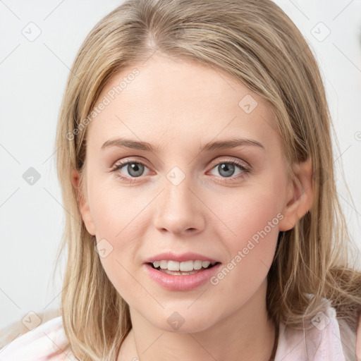 Joyful white young-adult female with medium  brown hair and blue eyes