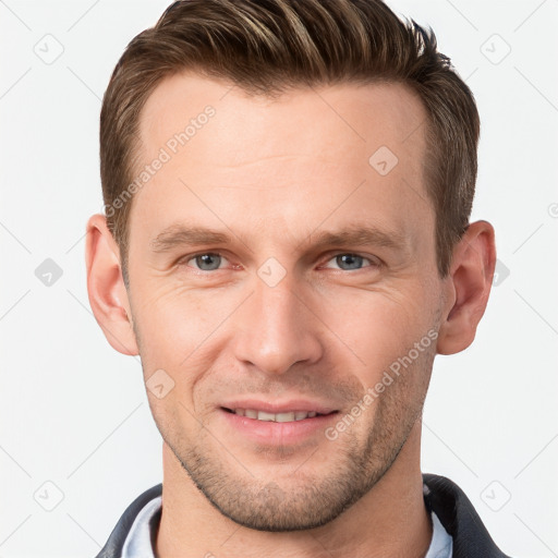 Joyful white young-adult male with short  brown hair and grey eyes