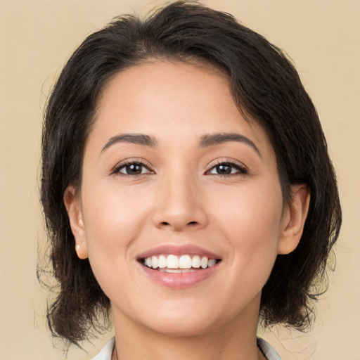 Joyful white young-adult female with medium  brown hair and brown eyes