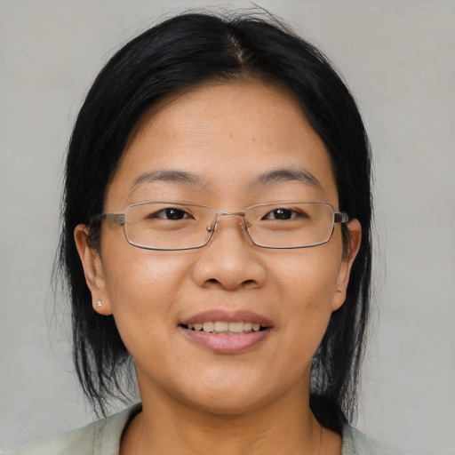 Joyful asian adult female with medium  brown hair and brown eyes