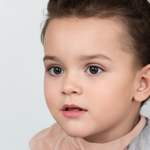 Joyful white child female with short  brown hair and brown eyes