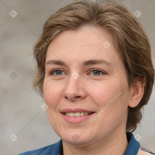 Joyful white adult female with medium  brown hair and blue eyes