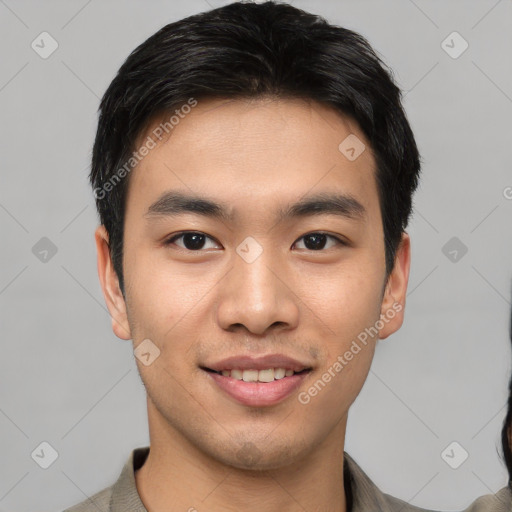 Joyful asian young-adult male with short  black hair and brown eyes