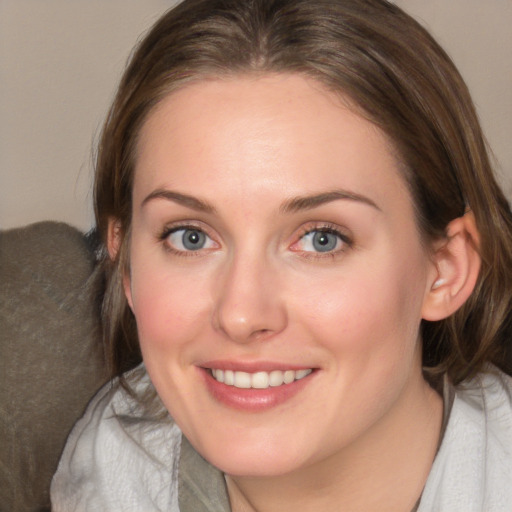 Joyful white young-adult female with medium  brown hair and blue eyes