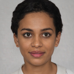 Joyful latino young-adult female with short  brown hair and brown eyes