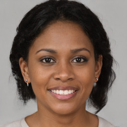 Joyful black young-adult female with medium  brown hair and brown eyes