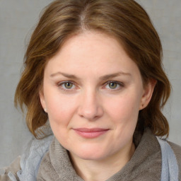 Joyful white young-adult female with medium  brown hair and blue eyes