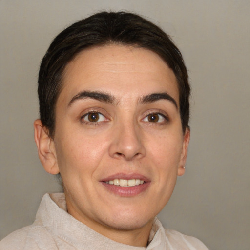 Joyful white adult female with short  brown hair and brown eyes