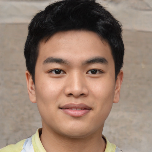 Joyful asian young-adult male with short  black hair and brown eyes