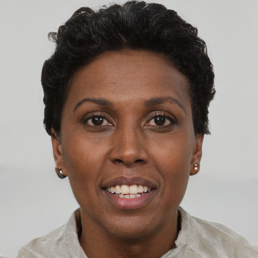 Joyful black adult female with short  brown hair and brown eyes