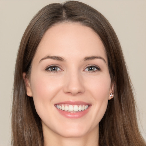 Joyful white young-adult female with long  brown hair and brown eyes