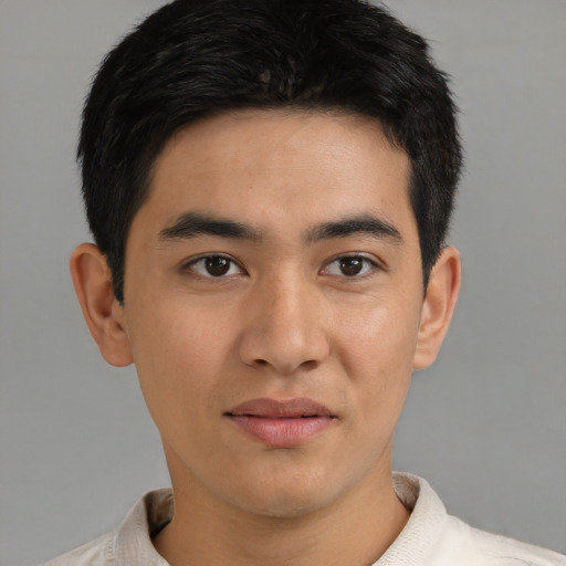 Joyful latino young-adult male with short  brown hair and brown eyes