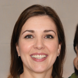 Joyful white adult female with medium  brown hair and brown eyes