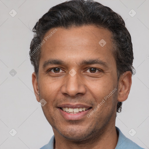 Joyful latino adult male with short  brown hair and brown eyes