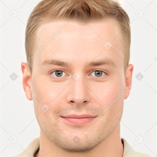 Joyful white young-adult male with short  brown hair and grey eyes