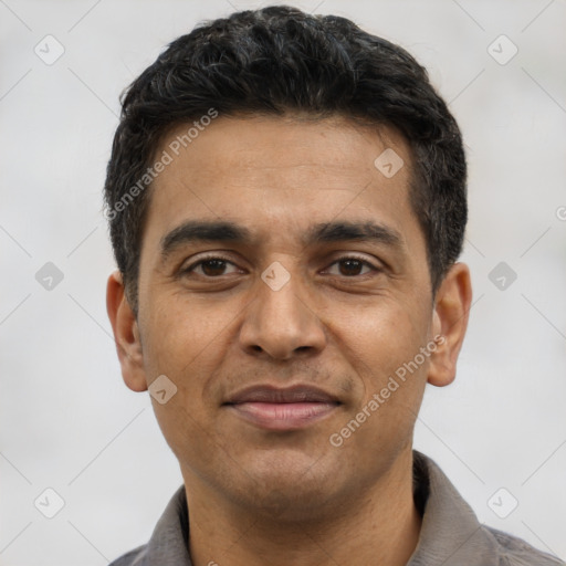 Joyful latino young-adult male with short  black hair and brown eyes