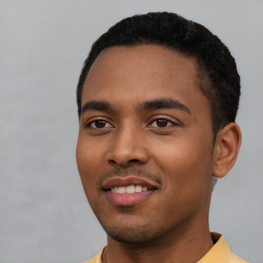 Joyful latino young-adult male with short  black hair and brown eyes