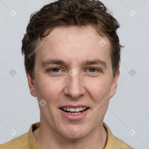 Joyful white adult male with short  brown hair and grey eyes