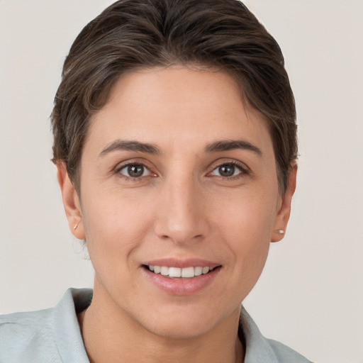 Joyful white young-adult female with short  brown hair and brown eyes