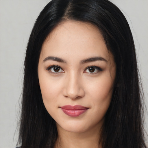 Joyful latino young-adult female with long  black hair and brown eyes