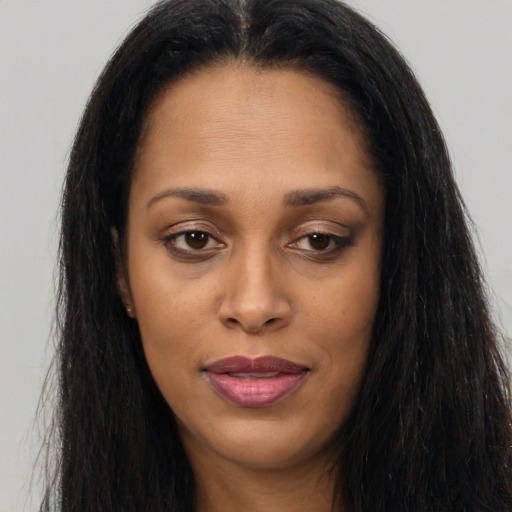 Joyful asian young-adult female with long  brown hair and brown eyes