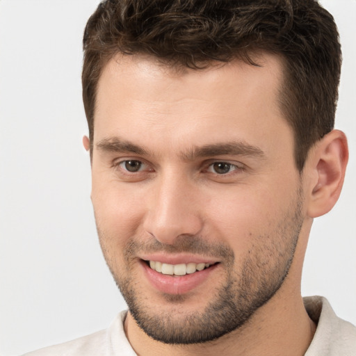 Joyful white young-adult male with short  brown hair and brown eyes