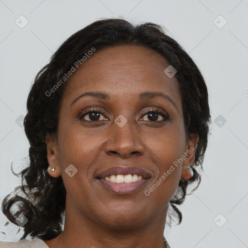 Joyful black adult female with medium  brown hair and brown eyes