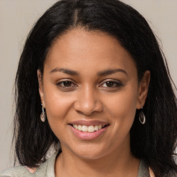 Joyful latino young-adult female with long  brown hair and brown eyes