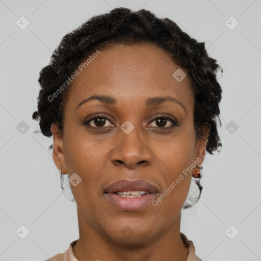 Joyful black adult female with short  brown hair and brown eyes