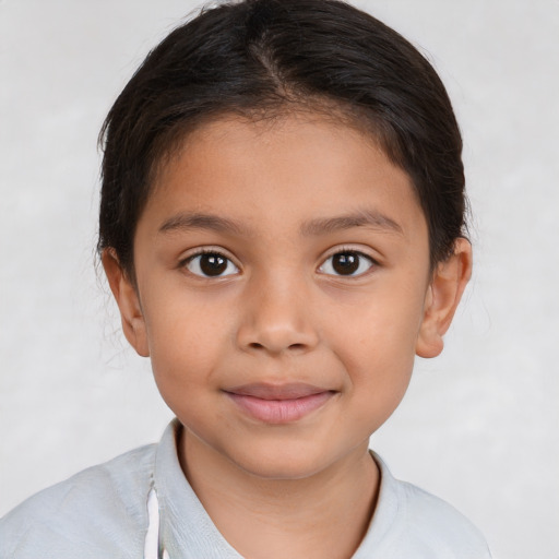 Joyful latino child female with short  brown hair and brown eyes