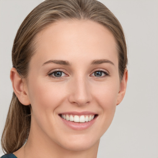 Joyful white young-adult female with medium  brown hair and blue eyes