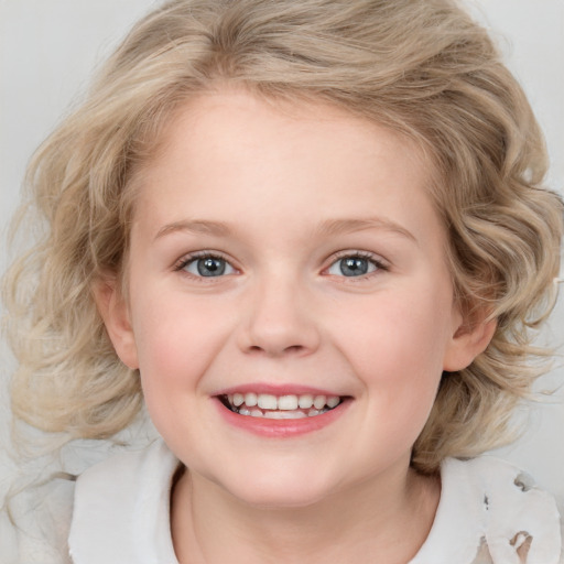 Joyful white child female with medium  blond hair and blue eyes