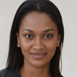 Joyful black young-adult female with long  brown hair and brown eyes