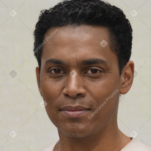 Joyful black young-adult male with short  black hair and brown eyes