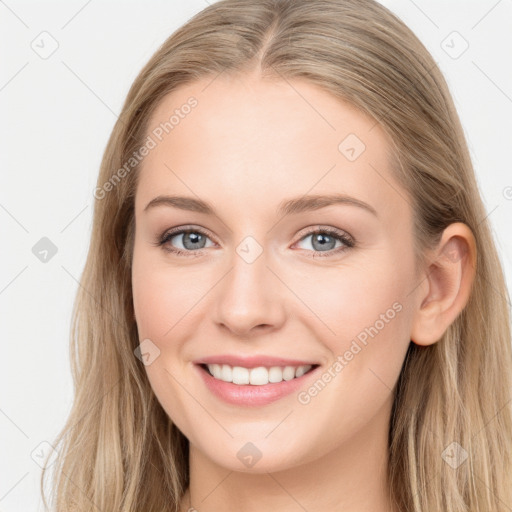 Joyful white young-adult female with long  brown hair and blue eyes