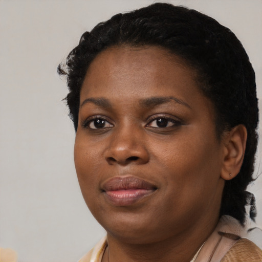 Joyful black young-adult female with medium  black hair and brown eyes